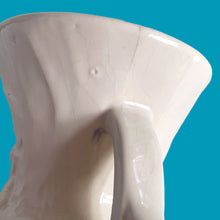 Load image into Gallery viewer, Beautiful vintage Bird of Paradise vase glazed in gloss white, features embossed bird and botanicals. Crafted by McCoy Pottery, 1940s. This vase is must for any art pottery collector!

In vintage condition, no repairs, chip on the foot. There is crazing present and one of the lines penetrates both sides at the rim, and appears stable. Maker&#39;s mark on the bottom.

Measures 4 7/8 x 3 3/4 x 8 inches
