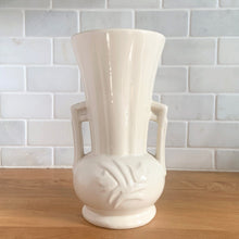 Load image into Gallery viewer, Vintage Art Deco gloss white handled trumpet vase with embossed flowers. Crafted by McCoy Pottery, 1950s. This rare piece is must for any McCoy art pottery collector!

In excellent vintage condition, no chips/cracks/repairs. Maker&#39;s mark.

Measures 4 1/4 x 8 1/8 inches
