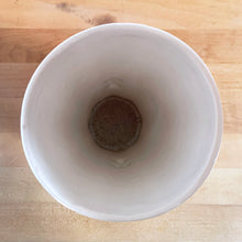 Load image into Gallery viewer, Vintage Art Deco gloss white handled trumpet vase with embossed flowers. Crafted by McCoy Pottery, 1950s. This rare piece is must for any McCoy art pottery collector!

In excellent vintage condition, no chips/cracks/repairs. Maker&#39;s mark.

Measures 4 1/4 x 8 1/8 inches

