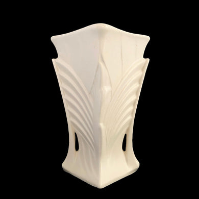 Exceptionally beautiful vintage matte white art deco vase, features a double fan design on a square trumpet shaped vase. Crafted by McCoy Pottery, 1943. This rare vase must for any art pottery collector!

In excellent vintage condition, no chips/cracks/repairs or noticeable crazing. Maker's mark on the bottom.

Measures 6 1/2 x 9 1/4 inches