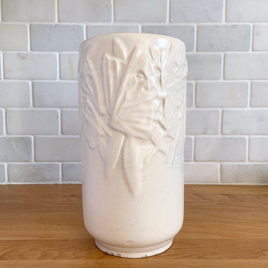 Vintage Art Deco matte white Butterfly Line cylinder vase. Crafted by Nelson McCoy Pottery, early 1940s. This rare piece is must for any art pottery collector! A lovely way to enhance your home's decor or give as a gift!

In good vintage condition, no chips/cracks/repairs. Heavy age-related crazing, manufacturer's glaze pops. Maker's marks.

Measures 4 3/8 x 8 1/8 inches