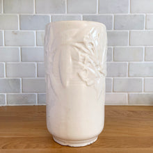 Load image into Gallery viewer, Vintage Art Deco matte white Butterfly Line cylinder vase. Crafted by Nelson McCoy Pottery, early 1940s. This rare piece is must for any art pottery collector! A lovely way to enhance your home&#39;s decor or give as a gift!

In good vintage condition, no chips/cracks/repairs. Heavy age-related crazing, manufacturer&#39;s glaze pops. Maker&#39;s marks.

Measures 4 3/8 x 8 1/8 inches
