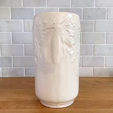 Load image into Gallery viewer, Vintage Art Deco matte white Butterfly Line cylinder vase. Crafted by Nelson McCoy Pottery, early 1940s. This rare piece is must for any art pottery collector! A lovely way to enhance your home&#39;s decor or give as a gift!

In good vintage condition, no chips/cracks/repairs. Heavy age-related crazing, manufacturer&#39;s glaze pops. Maker&#39;s marks.

Measures 4 3/8 x 8 1/8 inches
