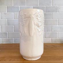 Load image into Gallery viewer, Vintage Art Deco matte white Butterfly Line cylinder vase. Crafted by Nelson McCoy Pottery, early 1940s. This rare piece is must for any art pottery collector! A lovely way to enhance your home&#39;s decor or give as a gift!

In good vintage condition, no chips/cracks/repairs. Heavy age-related crazing, manufacturer&#39;s glaze pops. Maker&#39;s marks.

Measures 4 3/8 x 8 1/8 inches
