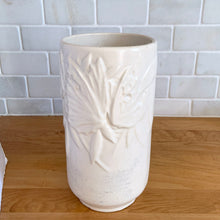 Load image into Gallery viewer, Vintage Art Deco matte white Butterfly Line cylinder vase. Crafted by Nelson McCoy Pottery, early 1940s. This rare piece is must for any art pottery collector! A lovely way to enhance your home&#39;s decor or give as a gift!

In good vintage condition, no chips/cracks/repairs. Heavy age-related crazing, manufacturer&#39;s glaze pops. Maker&#39;s marks.

Measures 4 3/8 x 8 1/8 inches
