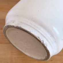 Load image into Gallery viewer, Vintage Art Deco matte white Butterfly Line cylinder vase. Crafted by Nelson McCoy Pottery, early 1940s. This rare piece is must for any art pottery collector! A lovely way to enhance your home&#39;s decor or give as a gift!

In good vintage condition, no chips/cracks/repairs. Heavy age-related crazing, manufacturer&#39;s glaze pops. Maker&#39;s marks.

Measures 4 3/8 x 8 1/8 inches
