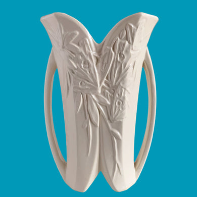 Exceptionally beautiful vintage matte white Butterfly Line vase, features clusters of butterflies on the front and back, a unique split foot and strap handles. Crafted by McCoy Pottery, early 1940s. This rare vase must for any art pottery collector!

In excellent vintage condition, no chips, no cracks, no repairs, crazing commensurate with age. Impressed 'USA' mark on the split foot.

Measures 6 1/2 x 5 1/2 x 10 3/8 inches