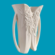 Load image into Gallery viewer, Exceptionally beautiful vintage matte white Butterfly Line vase, features clusters of butterflies on the front and back, a unique split foot and strap handles. Crafted by McCoy Pottery, early 1940s. This rare vase must for any art pottery collector!

In excellent vintage condition, no chips, no cracks, no repairs, crazing commensurate with age. Impressed &#39;USA&#39; mark on the split foot.

Measures 6 1/2 x 5 1/2 x 10 3/8 inches
