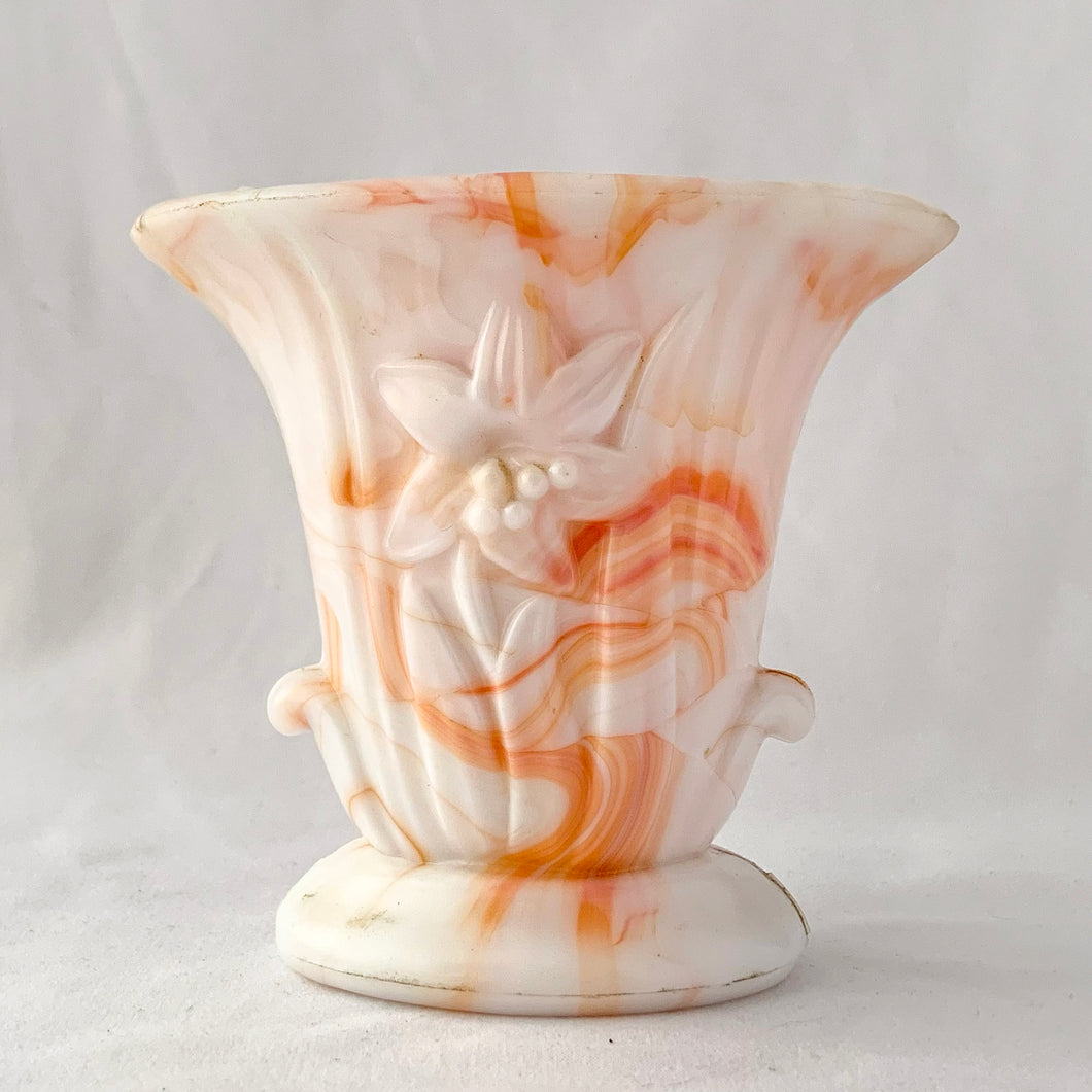 Vintage orange and white slag glass urn with embossed flower. Produced by Akro Agate, circa 1940s. These were produced for Jean Vivaudou Co. as packaging for their sachet products. Use as a bud vase or planter or repurpose to hold make-up brushes or pens/pencils.  In good vintage condition, with minor chips to the rim. Marked 