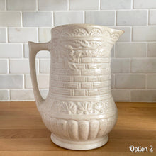 Load image into Gallery viewer, Antique vintage art deco matte white Rosella no. 320 ceramic yellow ware pitcher featuring climbing roses on a basketweave pattern. Crafted by Robinson Ransbottom Pottery Co., USA, 1920s. A beautiful piece of art pottery to add to collection. Makes a wonderful vessel for a floral arrangement.

Option 2: 6 1/2 x 7 5/8 inches
In as found vintage condition, chips to the spout, no cracks/repairs, age-related crazing and typical manufacturing glaze pops. Maker&#39;s mark.

