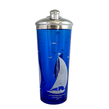 Load image into Gallery viewer, This iconic vintage cobalt blue glass cocktail shaker features white sailboats and sea birds, topped with a chrome lid. Crafted by Hazel-Atlas Glass, USA, 1930s. Reclaim the pleasure of being your home&#39;s star bartending mixologist...no Googling required!

In great vintage condition, no chips. The glass and lid shows age-related wear.

Measures 3 3/4 x 9 3/4 inches

Capacity 24 ounces

