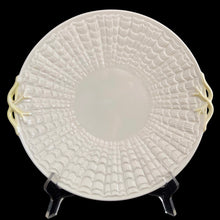 Load image into Gallery viewer, Belleek Tridacna handled cake plate, front-facing view on display stand showing full radiating shell relief and scalloped rim, vintage Irish porcelain
