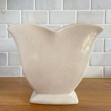 Load image into Gallery viewer, Vintage white tulip vase. Crafted by McCoy Pottery, USA, 1940s. This collectible vase is the perfect for a charming floral bouquet and makes a lovely gift for an art pottery collector.

In as found vintage condition, chip to the underside of the foot, significant age-related crazing, tight hairline crack, manufacturer&#39;s glaze pops. Maker&#39;s mark.

Measures 7 1/2 x 3 3/4 x 6 1/8 inches
