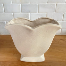 Load image into Gallery viewer, Vintage white tulip vase. Crafted by McCoy Pottery, USA, 1940s. This collectible vase is the perfect for a charming floral bouquet and makes a lovely gift for an art pottery collector.

In as found vintage condition, chip to the underside of the foot, significant age-related crazing, tight hairline crack, manufacturer&#39;s glaze pops. Maker&#39;s mark.

Measures 7 1/2 x 3 3/4 x 6 1/8 inches
