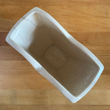 Load image into Gallery viewer, Vintage white tulip vase. Crafted by McCoy Pottery, USA, 1940s. This collectible vase is the perfect for a charming floral bouquet and makes a lovely gift for an art pottery collector.

In as found vintage condition, chip to the underside of the foot, significant age-related crazing, tight hairline crack, manufacturer&#39;s glaze pops. Maker&#39;s mark.

Measures 7 1/2 x 3 3/4 x 6 1/8 inches

