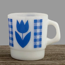 Load image into Gallery viewer, Vintage milk glass mug with vibrant blue tulip flowers and gingham check bands. Crafted by Termoscrisa Glass, Mexico. Circa 1980s. Perfect for your cuppa Joe!  In excellent condition, no chips/wear.  Measures 3 x 3 3/8 inches. Capacity 8 ounces
