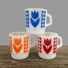 Load image into Gallery viewer, Vintage milk glass mug with vibrant tulip flowers and gingham check bands. Choose from red, orange or blue. Crafted by Termoscrisa Glass, Mexico. Circa 1980s. Perfect for your cuppa Joe!  In excellent condition, no chips/wear.  Measures 3 x 3 3/8 inches  Capacity 8 ounces
