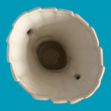Load image into Gallery viewer, Vintage shiny white glazed ribbon strap vase with double handles. Crafted by McCoy Pottery, 1940s. A must for any art pottery collector!

In excellent condition, no chips, no cracks, no repairs and no visible crazing which is incredible for a piece of this age. Maker&#39;s mark on the bottom.

Measures 7 3/4 x 12 inches

