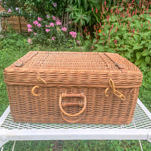 Load image into Gallery viewer, Vintage wicker picnic basket with leather fittings and 3 plastic chops plates and 1 cup.  In vintage condition with wear to the leather and plates.  Measures 18 x 8 x 7 1/2 inches
