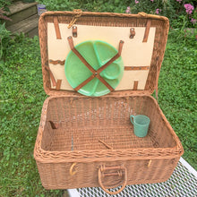 Load image into Gallery viewer, Vintage wicker picnic basket with leather fittings and 3 plastic chops plates and 1 cup.  In vintage condition with wear to the leather and plates.  Measures 18 x 8 x 7 1/2 inches
