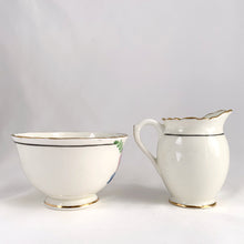 Load image into Gallery viewer, Vintage bone china wild flowers creamer and sugar, featuring hand painted florals in shades of pink, blue, yellow and green with gold gilt trim and scalloped edges. Crafted by Delphine China, England, 1920s. A lovely way to enhance your tea and coffee experience!

In excellent condition, no chips, cracks or repairs. Maker&#39;s mark on the bottom.

Creamer measures 1 7/8 x 2 3/4 inches | Sugar measures 3 5/8 x 2 1/4 inches
