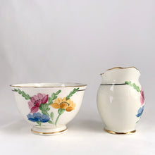 Load image into Gallery viewer, Vintage bone china wild flowers creamer and sugar, featuring hand painted florals in shades of pink, blue, yellow and green with gold gilt trim and scalloped edges. Crafted by Delphine China, England, 1920s. A lovely way to enhance your tea and coffee experience!

In excellent condition, no chips, cracks or repairs. Maker&#39;s mark on the bottom.

Creamer measures 1 7/8 x 2 3/4 inches | Sugar measures 3 5/8 x 2 1/4 inches
