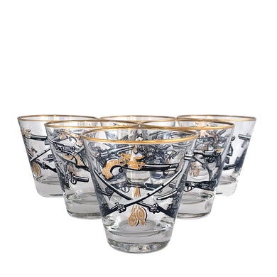 Set of six vintage wild west themed old fashioned glasses featuring revolvers and pistols in black, white and gold. Crafted by Libbey Glass, circa 1950s. A great addition to your barware collection!

In excellent condition, no chips. Marked on the bottom with the Libbey L.

Measures 3 1/2 x 3 1/2 inches

Capacity 8 ounces