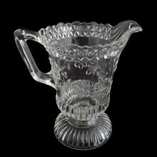 Load image into Gallery viewer, Full view of antique Adams &amp; Co. EAPG Wildflower #140 footed creamer pitcher displayed against a neutral background showing the complete form and clear pressed glass construction, c.1880
