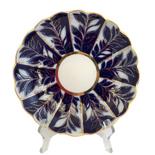 Load image into Gallery viewer, Vintage Lomonosov Imperial Porcelain saucer dish displayed on a clear acrylic stand, front view showing cobalt blue and white leaf pattern with gold accent detailing and scalloped rim, Russia
