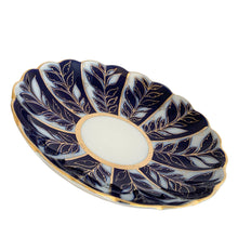 Load image into Gallery viewer, Angled three-quarter view of vintage Lomonosov Imperial Porcelain saucer dish showing the full cobalt blue and white botanical leaf pattern with gold line detailing, central ivory well, and gilt scalloped rim
