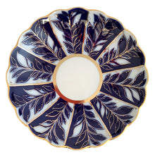 Load image into Gallery viewer, Overhead view of vintage Lomonosov Imperial Porcelain saucer dish showing the complete cobalt blue and white leaf spray pattern radiating from the central ivory well with gold rim accent
