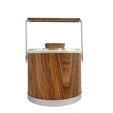 Vintage ice bucket featuring a chrome base, wood grained bucket, topped with a chrome and wood handle and lid; the interior is cream coloured plastic. Crafted by Kromex, USA, circa 1960s. A fabulous example of mid-century design and style!

In used excellent used condition. The handle and knob are in excellent condition. Marked on the bottom with Kromex and Made in the USA.

Measures 8 1/8 x 7 1/4 inches