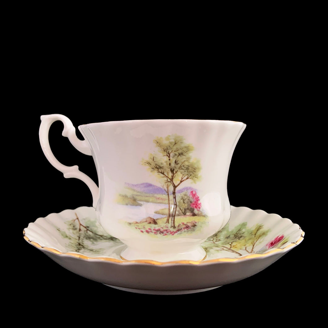 This vintage bone china footed teacup and saucer is so sweet! Both the cup and saucer are decorated with a woodland country scene with pink flowers. Each piece has a lovely scalloped shape, trimmed with gold gilt. Produced by Richmond, England, 1950s-70s.

In excellent condition, no chips, cracks or repairs. Maker's mark on the bottom.

Teacup measures 3 1/2 x 2 3/4 inches | Saucer measures 5 1/2 inches