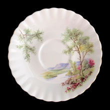 Load image into Gallery viewer, This vintage bone china footed teacup and saucer is so sweet! Both the cup and saucer are decorated with a woodland country scene with pink flowers. Each piece has a lovely scalloped shape, trimmed with gold gilt. Produced by Richmond, England, 1950s-70s.

In excellent condition, no chips, cracks or repairs. Maker&#39;s mark on the bottom.

Teacup measures 3 1/2 x 2 3/4 inches | Saucer measures 5 1/2 inches
