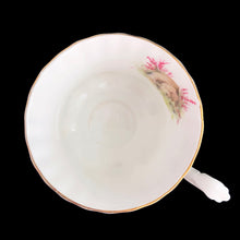 Load image into Gallery viewer, This vintage bone china footed teacup and saucer is so sweet! Both the cup and saucer are decorated with a woodland country scene with pink flowers. Each piece has a lovely scalloped shape, trimmed with gold gilt. Produced by Richmond, England, 1950s-70s.

In excellent condition, no chips, cracks or repairs. Maker&#39;s mark on the bottom.

Teacup measures 3 1/2 x 2 3/4 inches | Saucer measures 5 1/2 inches

