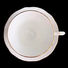 Load image into Gallery viewer, Vintage Woodside white bone china teacup and saucer features purple violets, trimmed in gold gilt. Crafted by Duchess, England, 1960s. A lovely way to enjoy a cuppa tea!

In excellent condition, no chips, cracks or repairs. Maker&#39;s mark on the bottom.

Measures 3 7/8 x 2 3/4 x 5 1/2 inches
