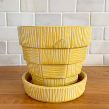 Load image into Gallery viewer, Highly collectible vintage mid-century yellow basketweave ceramic art pottery planter with attached underplate. Crafted by McCoy Pottery, USA, 1950s. The perfect home for your favourite houseplant or succulent!

In excellent vintage condition, no chips/cracks/repairs, age-related crazing. Maker&#39;s mark.

Measures 6 1/2 x 5 5/8 inches
