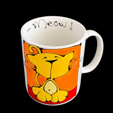Vintage white ceramic mug featuring an artisan designed and hand painted dimensionally (puffy) illustrated yellow cat set against an orange and red background, outlined in black with an inscription on the interior that reads 