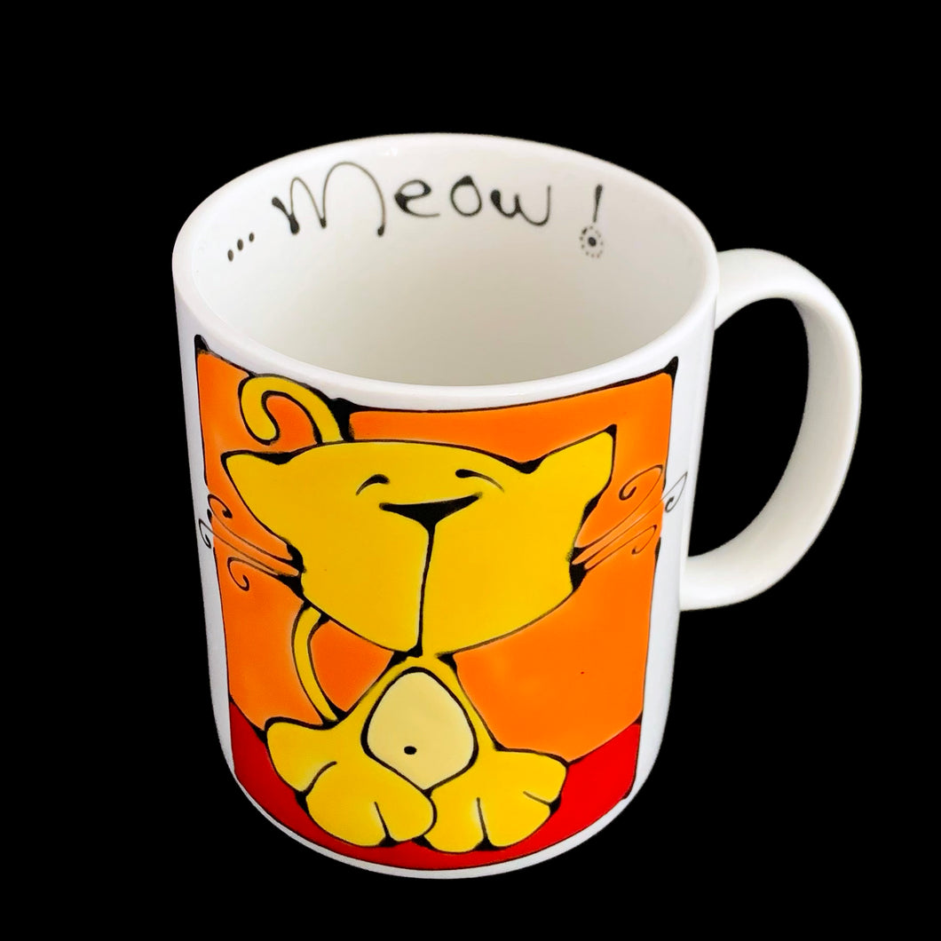 Vintage white ceramic mug featuring an artisan designed and hand painted dimensionally (puffy) illustrated yellow cat set against an orange and red background, outlined in black with an inscription on the interior that reads 