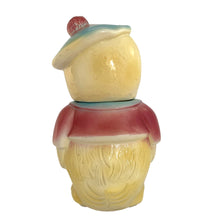 Load image into Gallery viewer, Vintage mid-century hand painted figural chick ceramic cookie jar, hand painted in shades of yellow, wearing a pink and blue jacket with black stitching and topped with a blue and pink beret. Crafted by American Bisque, USA, circa 1950s. Add some kitsch to your kitchen decor with this adorable collectible!

In excellent condition, minor chip on the underside of the foot, no cracks, age-related crazing.

Measures 6 x 7 x 11 3/4 inches
