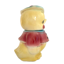 Load image into Gallery viewer, Vintage mid-century hand painted figural chick ceramic cookie jar, hand painted in shades of yellow, wearing a pink and blue jacket with black stitching and topped with a blue and pink beret. Crafted by American Bisque, USA, circa 1950s. Add some kitsch to your kitchen decor with this adorable collectible!

In excellent condition, minor chip on the underside of the foot, no cracks, age-related crazing.

Measures 6 x 7 x 11 3/4 inches
