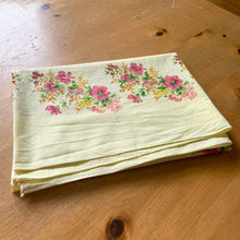 Load image into Gallery viewer, Add some vintage charm to your tablescape with this yellow cotton rectangular tablecloth featuring sprays of flowers in shades of pink, yellow, orange and green. Perfect for adding a hint of nostalgia to any gathering!  In excellent condition, free from stains/tears.  Measures 53 x 41 inches
