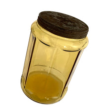 Load image into Gallery viewer, Antique eight sided yellow depression glass metal lidded tobacco canister. Early 1900s. Perfect for dry goods storage.

In vintage condition, significant wear to the lid with rust and tiny hole. Typical bubbles and stringers in the glass.

Measures 4 1/2 x 7 inches
