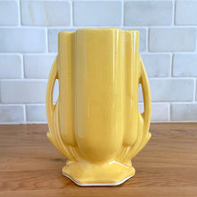 Load image into Gallery viewer, Vintage Art Deco yellow vase features a unique shape and double leaf decorative handles, 105. Crafted by McCoy Pottery, 1940s. This rare piece is must for any art pottery collector! A lovely way to enhance your home&#39;s decor or give as a gift!

In excellent vintage condition, no chips/cracks/repairs. Typical age-related crazing, manufacturer&#39;s glaze pops. Unmarked.

Measures 4 x 2 1/8 x 5 1/2 inches
