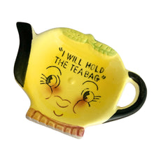 Load image into Gallery viewer, Adorable vintage mid-century hand painted figural ceramic yellow teapot teabag holder dish featuring the inscription &quot;I will hold the teabag&quot; atop a smiling face. The teabag holder can be displayed vertically when not in use as part of your kitsch kitchen decor....so cute!  In excellent condition, no chips/cracks/repairs. Marked &quot;Japan&quot;.  Measures 4 1/4 x 3 inches
