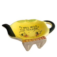 Load image into Gallery viewer, Adorable vintage mid-century hand painted figural ceramic yellow teapot teabag holder dish featuring the inscription &quot;I will hold the teabag&quot; atop a smiling face. The teabag holder can be displayed vertically when not in use as part of your kitsch kitchen decor....so cute!  In excellent condition, no chips/cracks/repairs. Marked &quot;Japan&quot;.  Measures 4 1/4 x 3 inches
