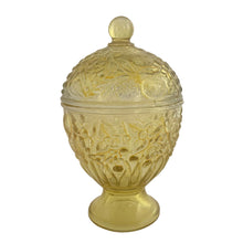 Load image into Gallery viewer, Vintage collectible Avon yellow flash ovoid-shaped lidded pedestal glass candy dish featuring an embossed floral pattern. Crafted by Fostoria Glass, USA, 1960/70s. This lovely accent piece has a fitted lid to keep contents fresh and dust-free, making it equally suited for displaying hard candies and mints, or repurposing for trinkets.

In excellent condition, no chips.

Measures 3 1/2 x 6 1/2 inches
