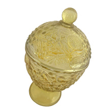 Load image into Gallery viewer, Vintage collectible Avon yellow flash ovoid-shaped lidded pedestal glass candy dish featuring an embossed floral pattern. Crafted by Fostoria Glass, USA, 1960/70s. This lovely accent piece has a fitted lid to keep contents fresh and dust-free, making it equally suited for displaying hard candies and mints, or repurposing for trinkets.

In excellent condition, no chips.

Measures 3 1/2 x 6 1/2 inches
