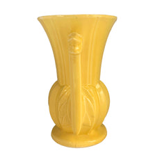 Load image into Gallery viewer, Exceptionally beautiful vintage gloss yellow art deco vase, features a melon base flowing into a trumpet shape finished with leaf topped handles. Crafted by McCoy Pottery, 1948. This rare vase must for any art pottery collector!

In as found vintage condition, no chips//repairs. There is a tight hairline crack on one of the handles and age-related crazing commensurate. Maker&#39;s mark on the bottom.

Measures 7 x 9 1/8 inches
