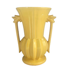 Load image into Gallery viewer, Exceptionally beautiful vintage gloss yellow art deco vase, features a melon base flowing into a trumpet shape finished with leaf topped handles. Crafted by McCoy Pottery, 1948. This rare vase must for any art pottery collector!

In as found vintage condition, no chips//repairs. There is a tight hairline crack on one of the handles and age-related crazing commensurate. Maker&#39;s mark on the bottom.

Measures 7 x 9 1/8 inches
